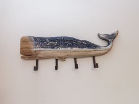 A whale-shaped wall decor with hooks at Hen Penmynydd in Llanfwrog near Llanfachraeth