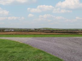 A view of fields and houses with gravel at Hen Penmynydd in Llanfwrog near Llanfachraeth