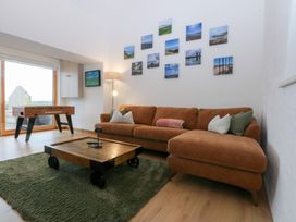 A living room with a sofa and coffee table at Hen Penmynydd Llanfwrog near Llanfachraeth