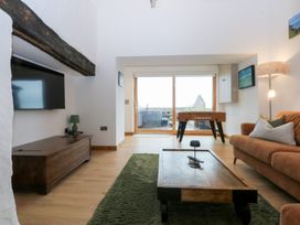 A living room with a foosball table and a sofa at Hen Penmynydd in Llanfwrog near Llanfachraeth