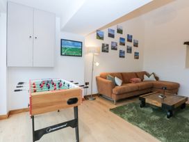 A living room with a foosball table and a sofa at Hen Penmynydd Llanfwrog near Llanfachraeth