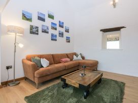 A living room with a sofa and coffee table at Hen Penmynydd Llanfwrog near Llanfachraeth