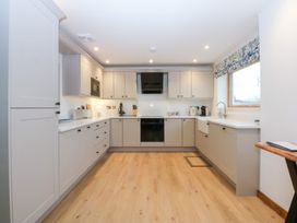A kitchen with appliances and cabinets at Hen Penmynydd in Llanfwrog near Llanfachraeth