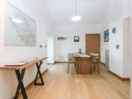 A dining room with a table and chairs at Hen Penmynydd in Llanfwrog near Llanfachraeth