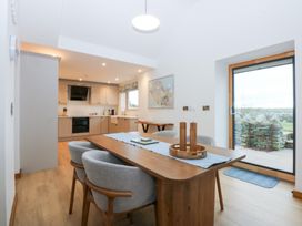 A dining room with a table and chairs at Hen Penmynydd Llanfwrog near Llanfachraeth