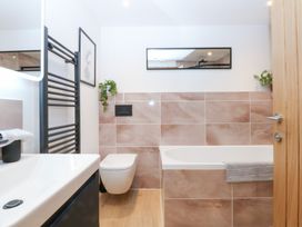 A bathroom with a bathtub and sink at Hen Penmynydd in Llanfwrog near Llanfachraeth