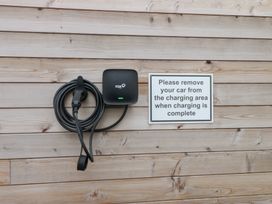A charging station and cable on a wooden wall at Hen Penmynydd Llanfwrog near Llanfachraeth