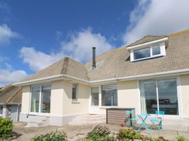 A house exterior with windows, door, and garden furniture at Shearwater in Praa Sands