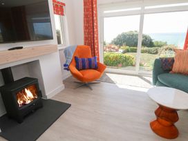 A living room with a television and fireplace at Shearwater in Praa Sands