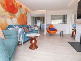 A living room with a sofa and table at Shearwater in Praa Sands