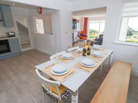 A dining room with a table set for meals at Shearwater in Praa Sands