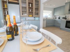A dining room with champagne and plates at Shearwater in Praa Sands