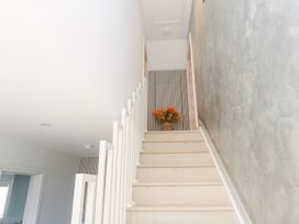 A staircase with a flower arrangement at Shearwater in Praa Sands