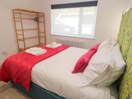 A bedroom with bed and shelf at Shearwater in Praa Sands