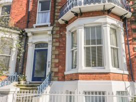 A building exterior with a blue door and railings at Esplanade Gardens, Apartment 1 in Scarborough