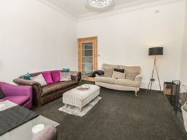 A living room with a sofa and coffee table at Esplanade Gardens, Apartment 1 Scarborough