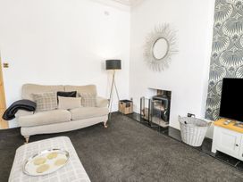 A living room with a sofa and television at Esplanade Gardens, Apartment 1 in Scarborough