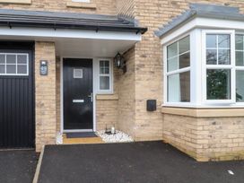 An entrance with a black door and window at 49 Mellings Place