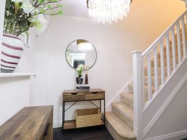 An entryway with a staircase and a console table at 49 Mellings Place 