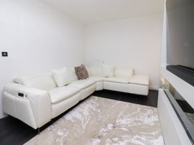 A living room with a sofa and rug at 49 Mellings Place