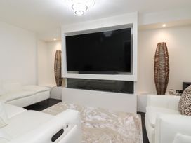 A living room with a television and sofa at 49 Mellings Place