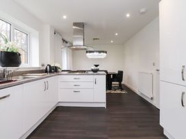 A kitchen with a dining area and modern appliances at 49 Mellings Place