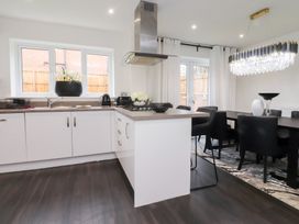 A kitchen with a dining area featuring a countertop and kitchen appliances at 49 Mellings Place