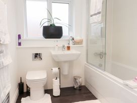 A bathroom with a toilet, sink, and bathtub at 49 Mellings Place