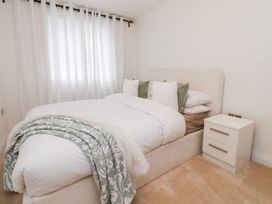 A bedroom with a bed and nightstand at 49 Mellings Place