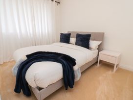 A bedroom with a bed and nightstand at 49 Mellings Place