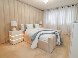 A bedroom with a bed and curtains at 49 Mellings Place 