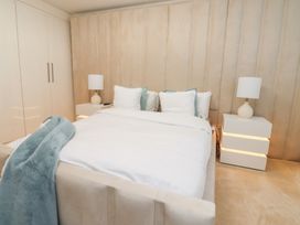 A bedroom with a bed and nightstands at 49 Mellings Place