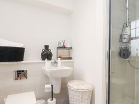 A bathroom with a toilet, sink, and shower at 49 Mellings Place