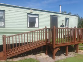 A mobile home with steps and railing at Caravan number 85