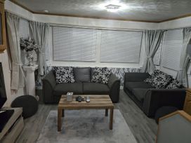 A living room with two sofas and a coffee table at Caravan number 85 
