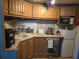 A kitchen with cabinets and appliances at Caravan number 85