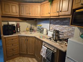 A kitchen with cabinets and appliances at Caravan number 85