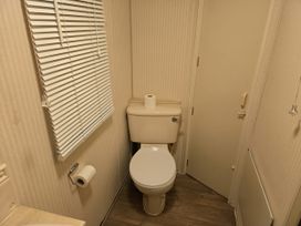 A bathroom with a toilet and a sink at Caravan number 85