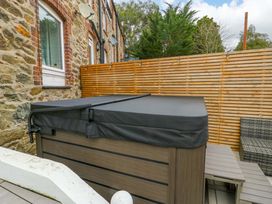 An outdoor area with a hot tub and patio furniture at 4 Brynteg Terrace Menai Bridge