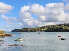 A view of boats on water with trees and clouds at 4 Brynteg Terrace Menai Bridge