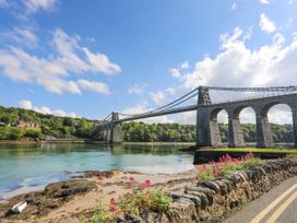 A bridge over water with flowers along the road at 4 Brynteg Terrace Menai Bridge