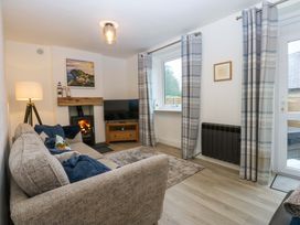 A living room with a sofa and television at 4 Brynteg Terrace Menai Bridge