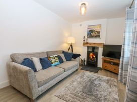 A living room with a sofa and a fireplace at 4 Brynteg Terrace Menai Bridge