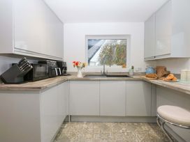 A kitchen with a sink and appliances at 4 Brynteg Terrace Menai Bridge