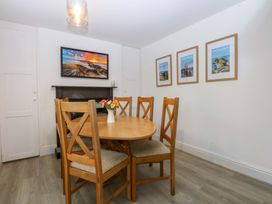 A dining room with a table and chairs at 4 Brynteg Terrace in Menai Bridge