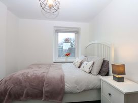 A bedroom with a bed and a window at 4 Brynteg Terrace in Menai Bridge