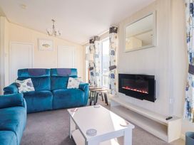 A living room with a sofa and coffee table at 91 Swanage Coastal Park in Swanage