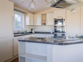 A kitchen with a countertop and appliances at 91 Swanage Coastal Park in Swanage