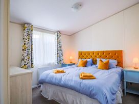 A bedroom with a bed and bedside tables at 91 Swanage Coastal Park in Swanage