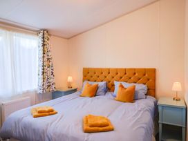 A bedroom with a double bed and bedside tables at 91 Swanage Coastal Park in Swanage